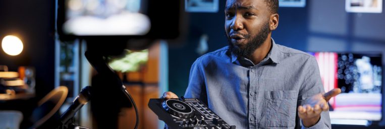 Content creator doing giveaway for his social media followers, offering DJ controller device to most loyal fan. Internet star happy to gift fanbase professional sound mixer as contest prize